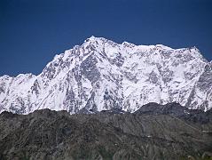 
We drove from Skardu to Tarashing over the Deosai Plains, a high alpine plateau scattered with small tufts of grass and small flowers. We came over a hill and there in front of was the enormous Rupal face of Nanga Parbat, standing alone on the horizon, shining brilliantly white in the sunshine. Starting on the left, the Mazeno Ridge leads to the Rupal Face of Nanga Parbat, and then the summit ridge leads down past the North Peaks to the Southeast Peak and East Peaks and then plummets to Rakhiot Peak.
